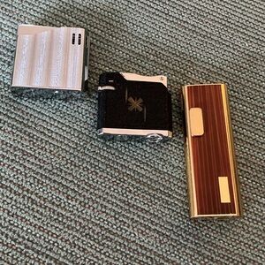 Three Vintage Pocket Lighters - Silver, Black, Gold/Brown